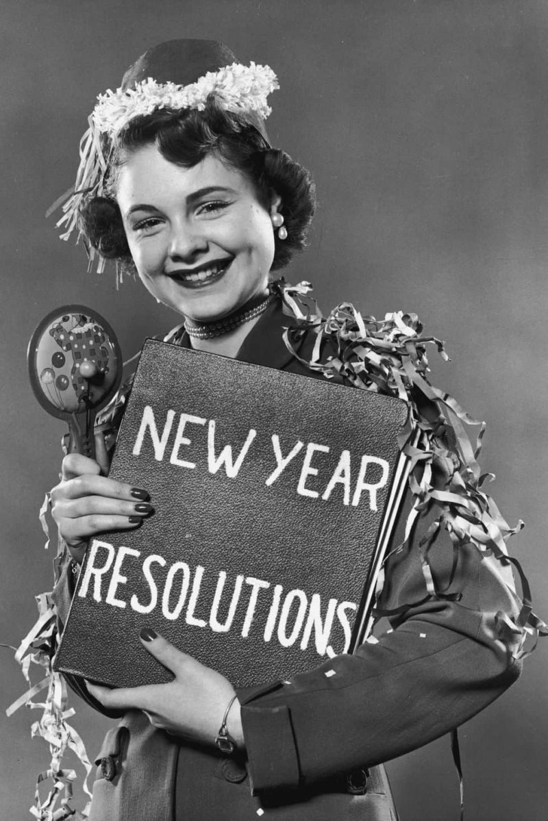 woman holding a new year resolution sign