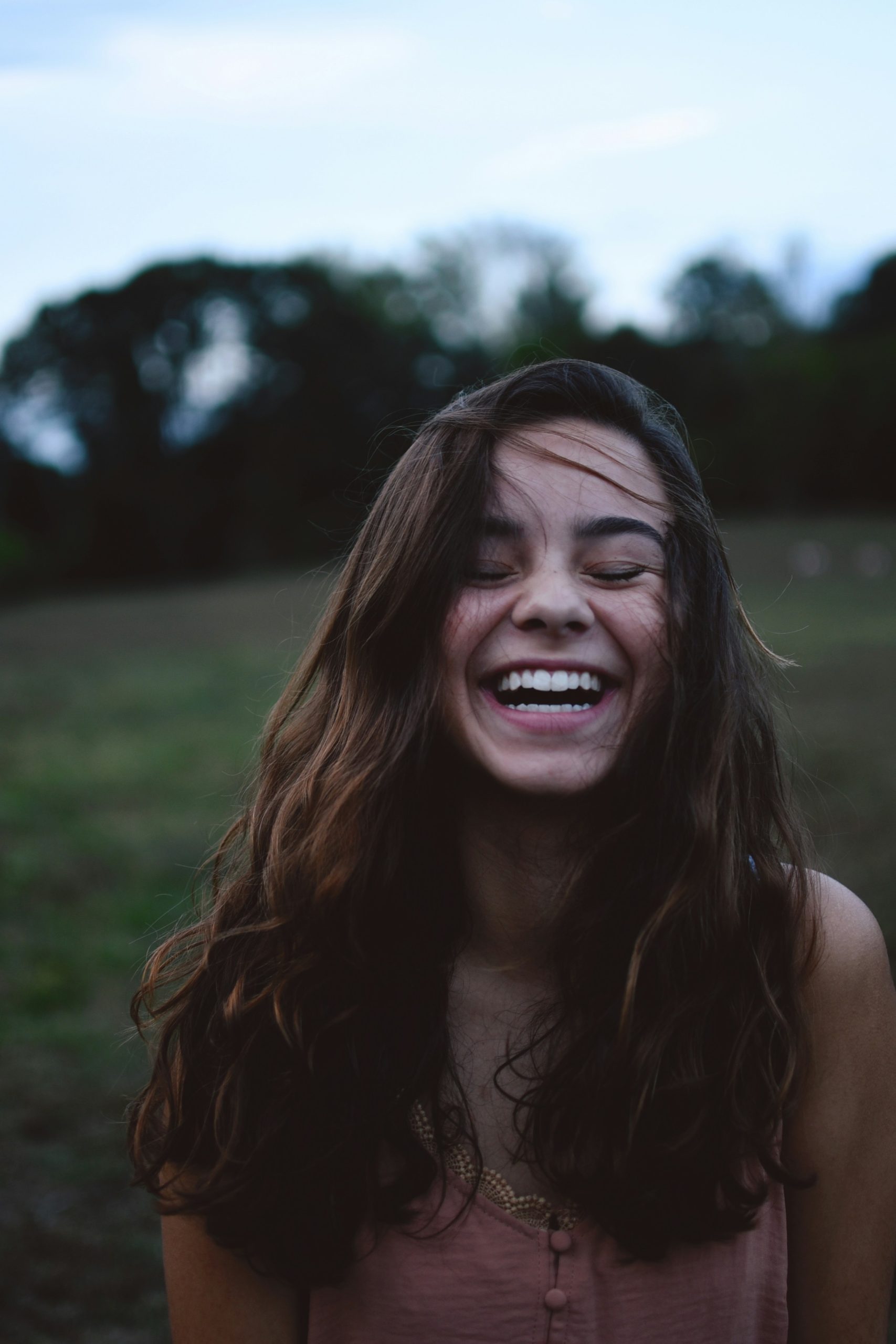 A girl smiling with her eyes closed.