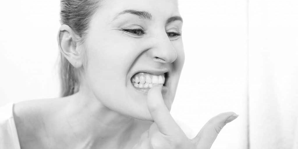 woman pointing to her bleeding gums
