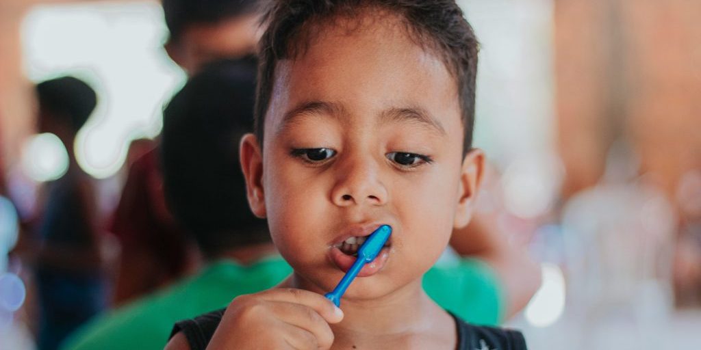 A child brushing their teeth