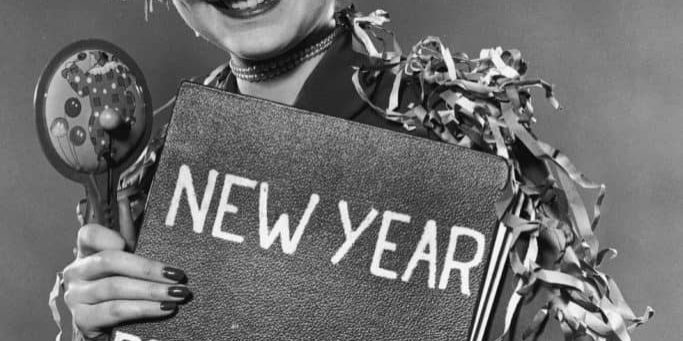woman holding a new year resolution sign